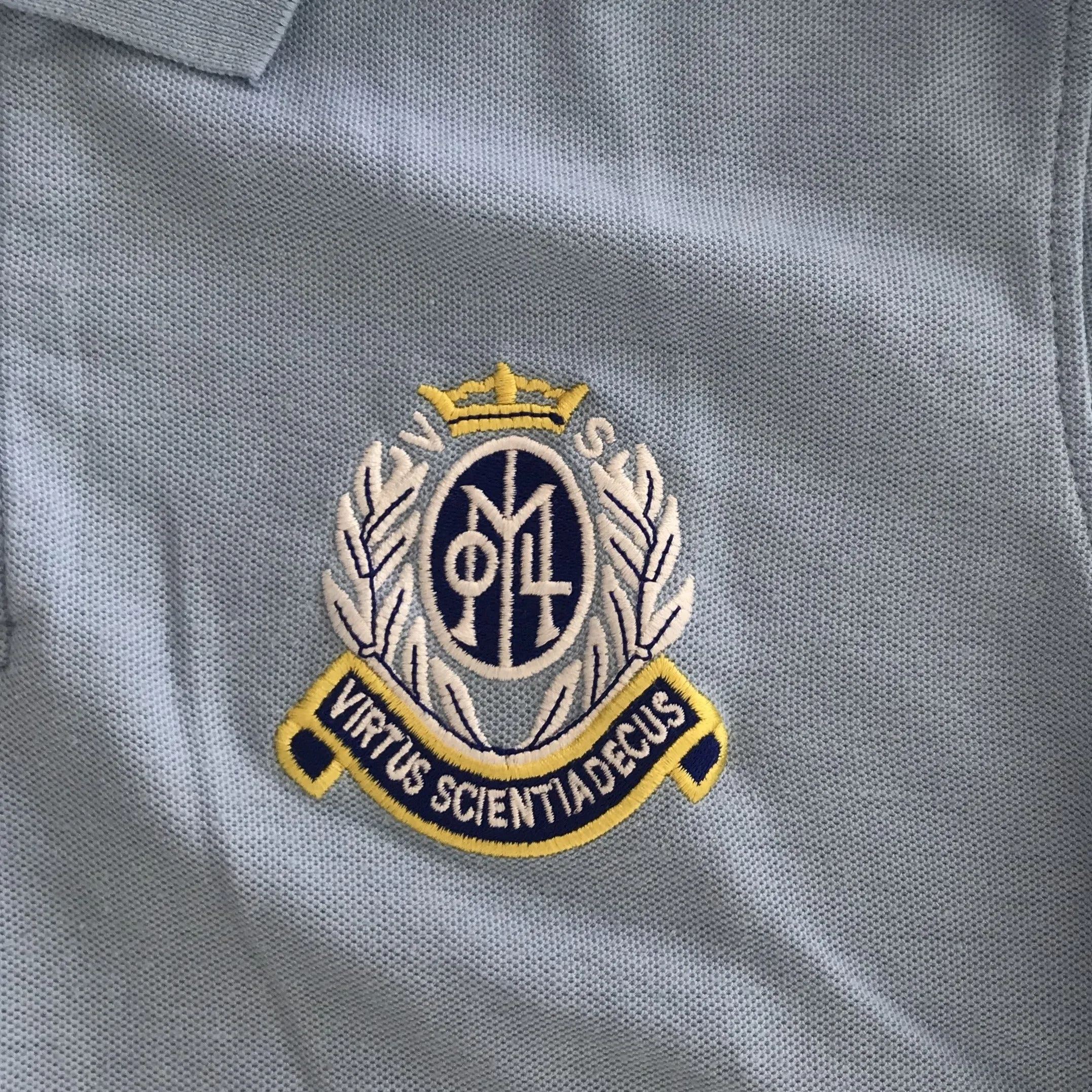 Our Lady of the Missions Primary light blue polo shirt